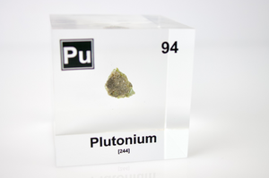 Plutonium element cube with dimension measurements on white background, collector gift