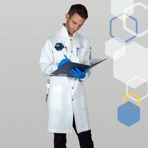 High collar howie style lab coat for men with tear away snaps for chemical splashes and fire. Male scientist is smiling while recording data in a laboratory notebook