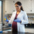 pregnant woman wearing a lab coat during maternity in a research laboratory. Her lab coat does not fit over her pregnant belly and exposes the baby to chemicals and fire risk