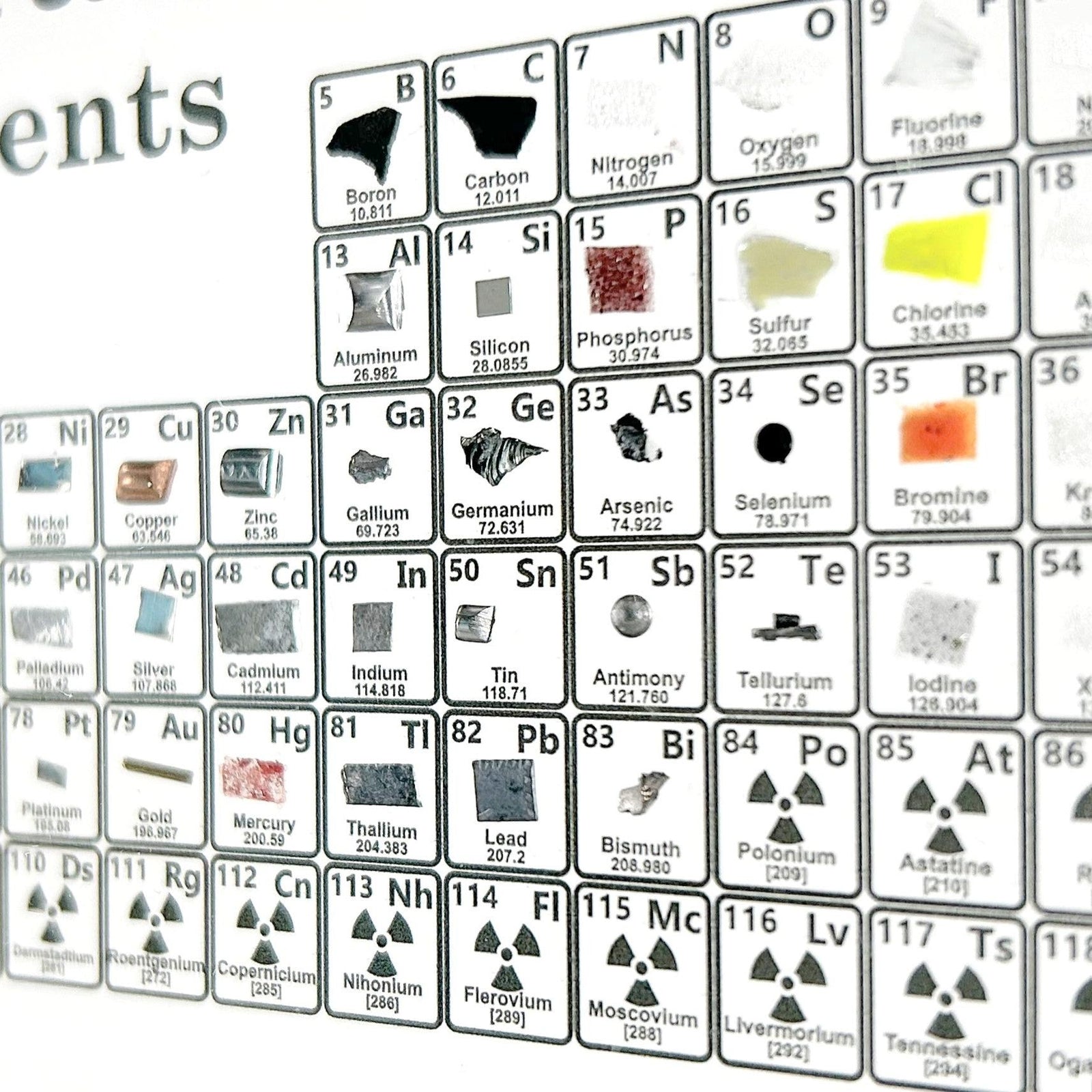 Heritage element table angled view showing depth of embedded real element samples, collector gift