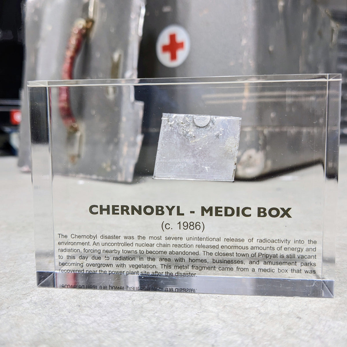 Chernobyl Medic Box acrylic display against Chernobyl site background, history collector gift