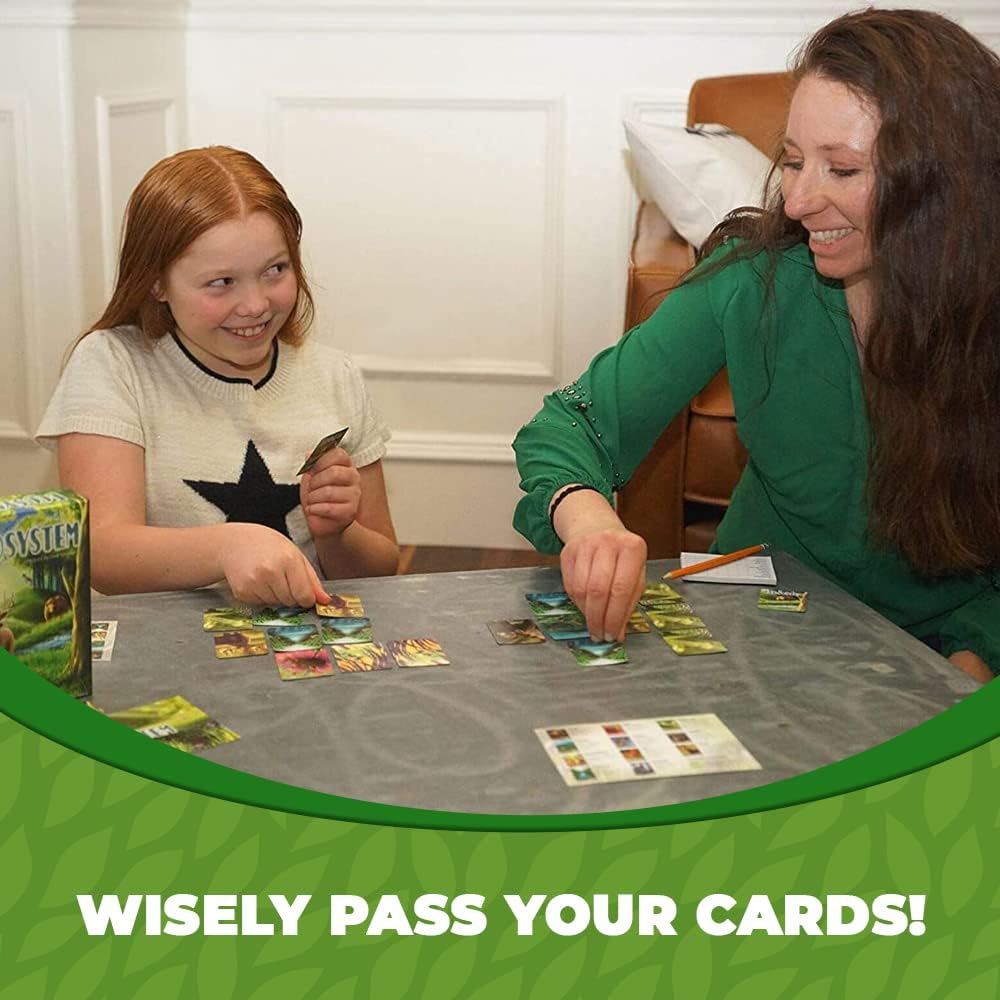 Ecosystem card game player hands and scored animal cards on table, educational gift