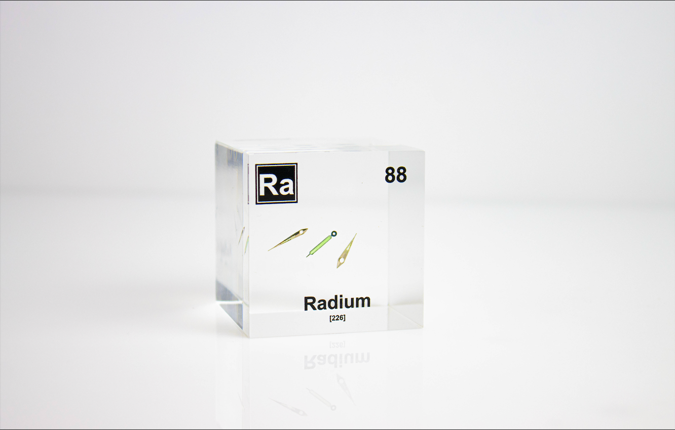 Radium element cube close-up showing metallic surface detail, collector gift