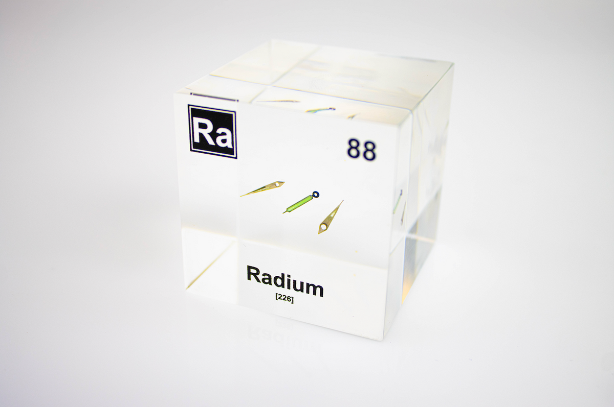 Radium element cube front view on white background, rare radioactive chemistry collector gift