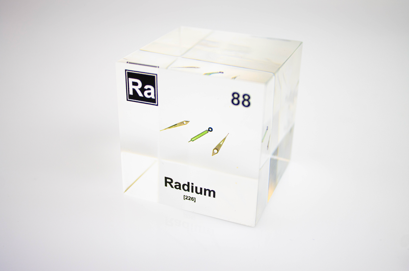 Radium element cube front view on white background, rare radioactive chemistry collector gift