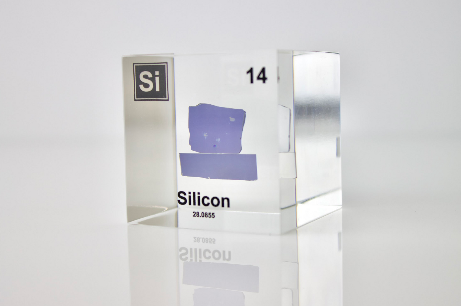 Silicon element cube in acrylic display on white background, collector gift for science enthusiasts