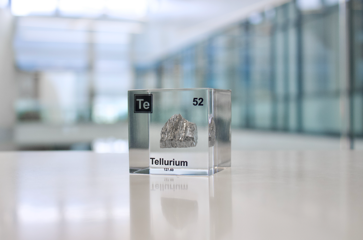 Tellurium element cube facing left on white background, collector gift for science enthusiasts