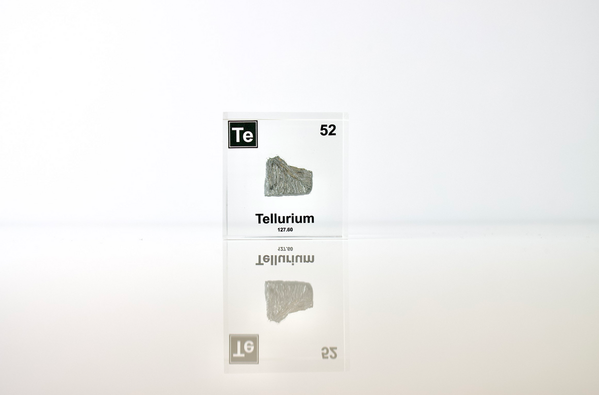 Tellurium element cube with dimension measurements on white background, collector gift