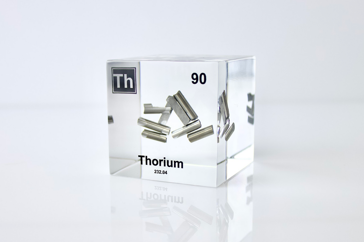 Thorium element cube front view on white background, rare radioactive collector gift for science fans
