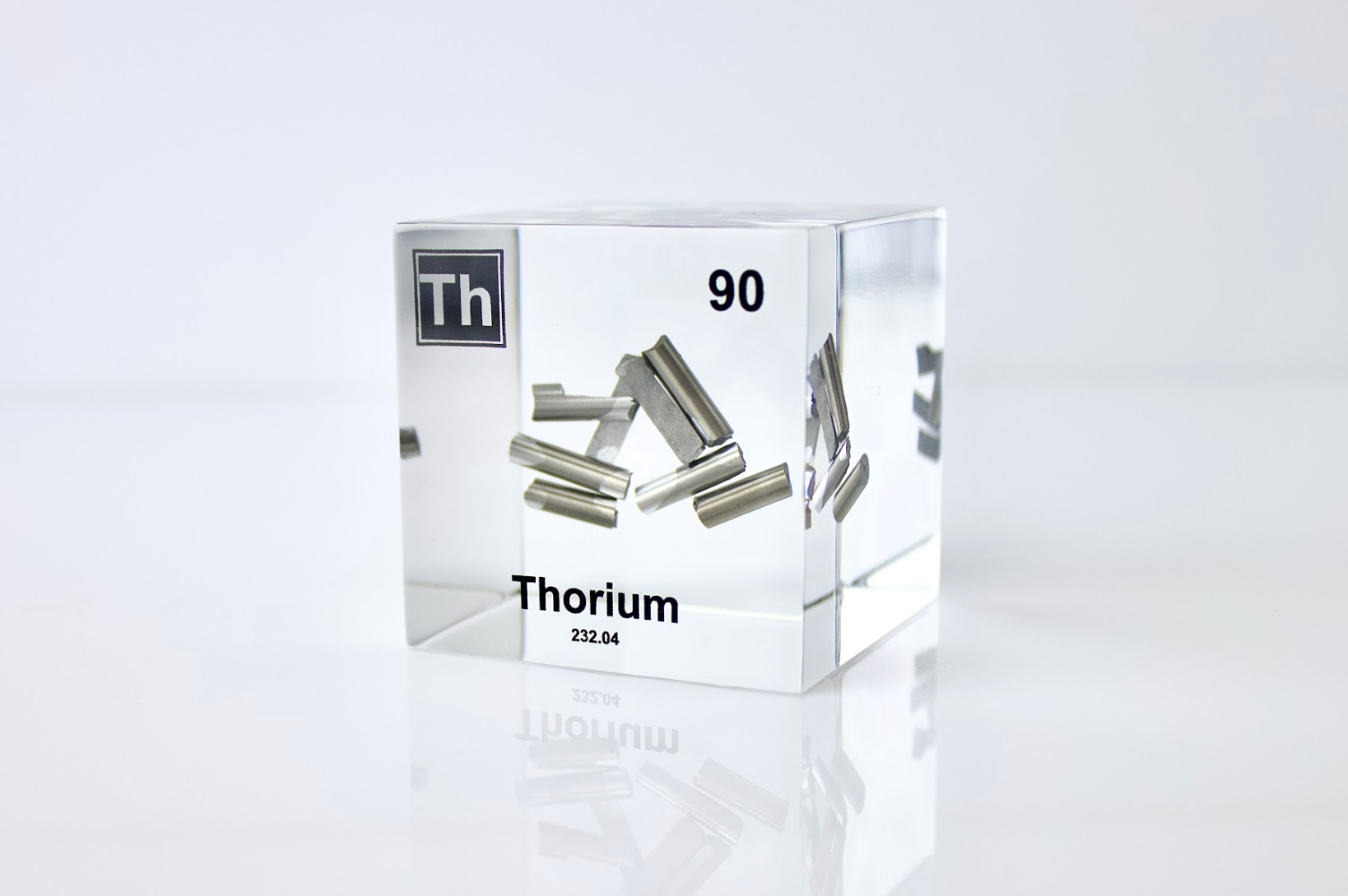 Thorium element cube front view on white background, rare radioactive collector gift for science fans