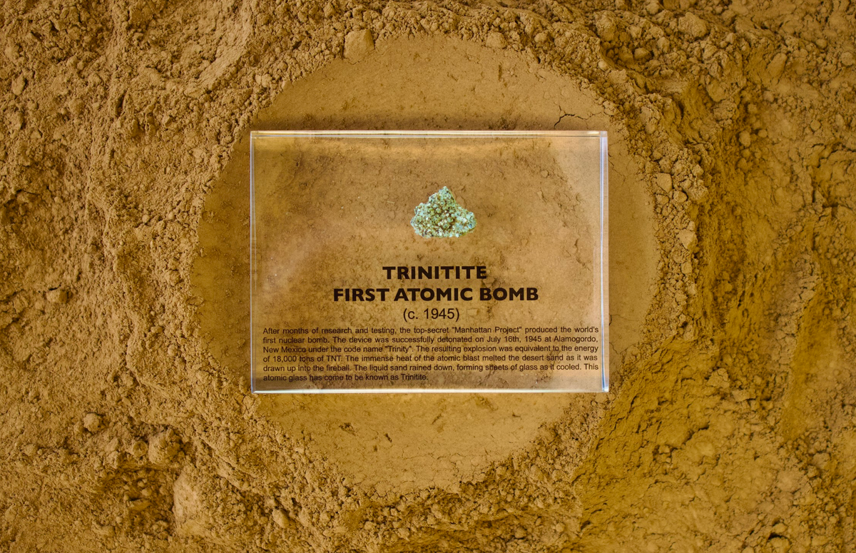 Trinitite specimen from the first atomic bomb test facing up on a textured background, collector gift