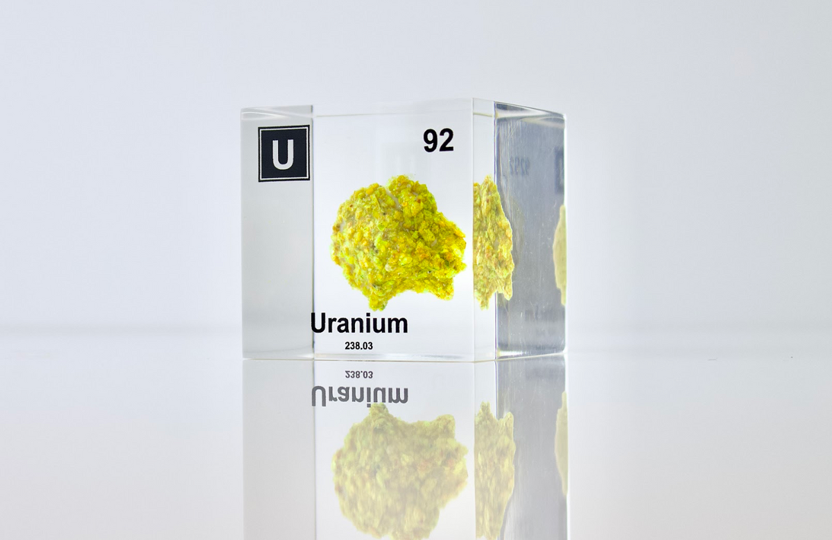 Uranium element cube facing left on white background, collector gift for nuclear science fans