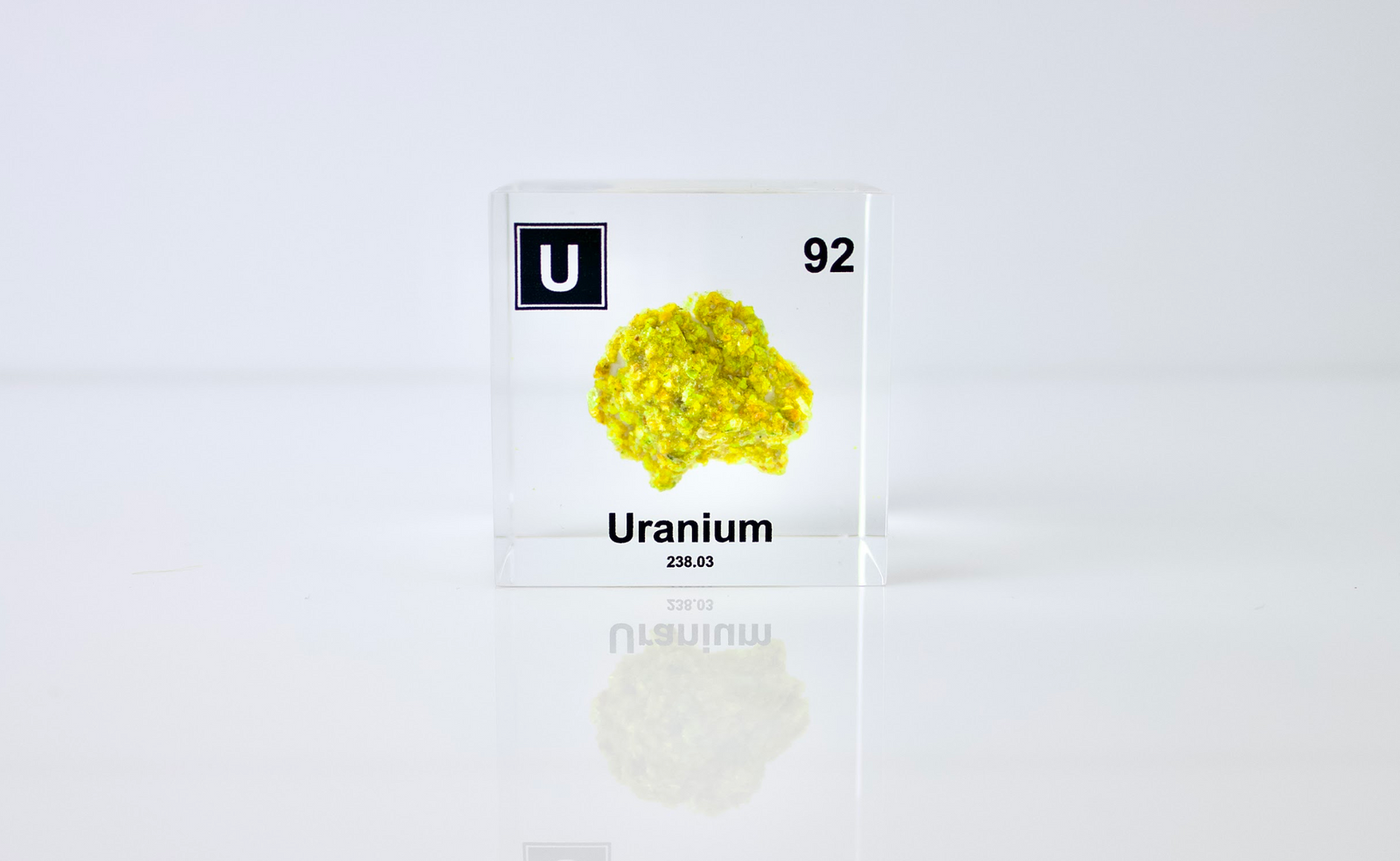 Uranium element cube front view on white background, collector gift for periodic table fans