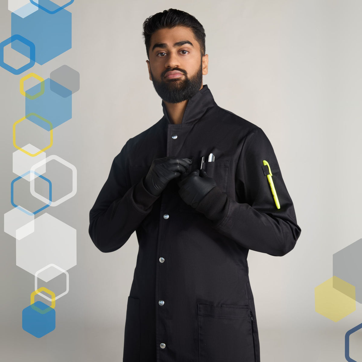 Male scientist wearing a medium black howie style lab coat for college chemistry class with metal poppers and long knit