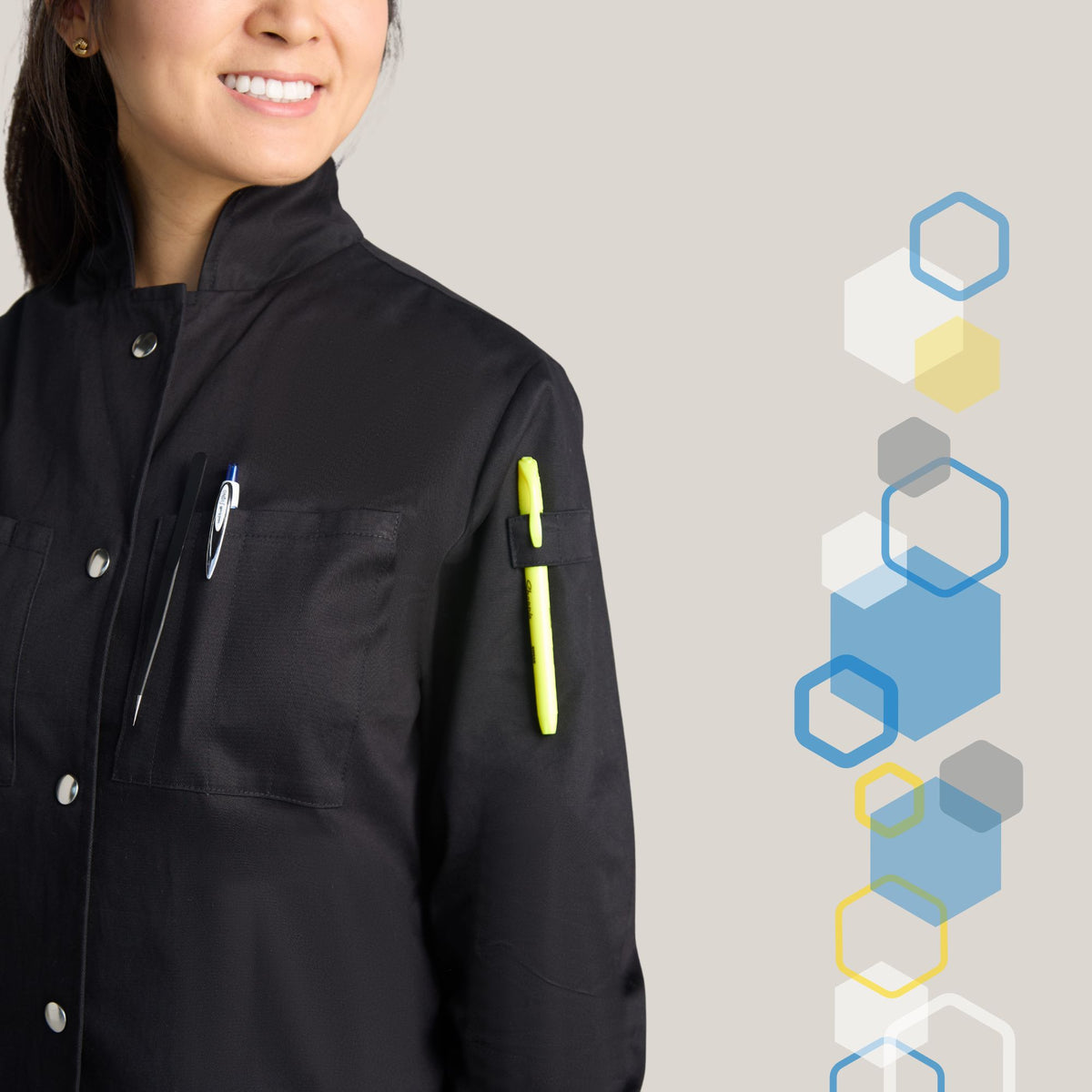 slender female smiling wearing a black chemical lab coat with metal snaps buttoned to the top of the neck and high collar to protect against chemistry lab accidents