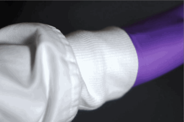 long soft knit cuffs on white lab coat covering wrists on purple nitrile gloves while reaching and rotating