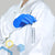 pregnant woman wearing maternity labcoat in chemistry research, reaching for a marker in a shoulder slot, wearing nitrile gloves with knit cuffs and cotton fabric
