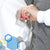 scientist woman wearing maternity lab coat with adjustable waistband to expand for 2nd and 3rd trimester of pregnancy, in white cotton, from genius lab gear