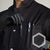 college chemistry student wearing a black 100 pct cotton lab coat and protective nitrile gloves inserting chemical lab tools in front breast pocket for storage