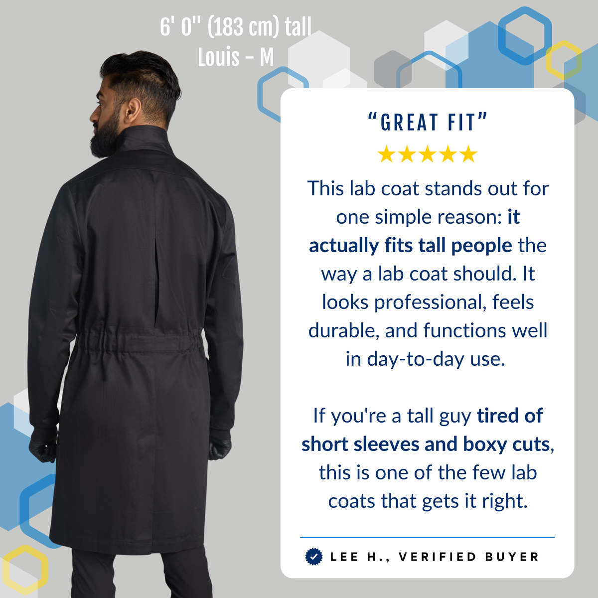 Tall male scientist (6'0) wearing The Louis men's black cotton lab coat in size medium, back view showing the pleated back and adjustable belt. Verified buyer testimonial: it actually fits tall people the way a lab coat should — no more short sleeves or boxy cuts for tall scientists in chemistry and research labs.