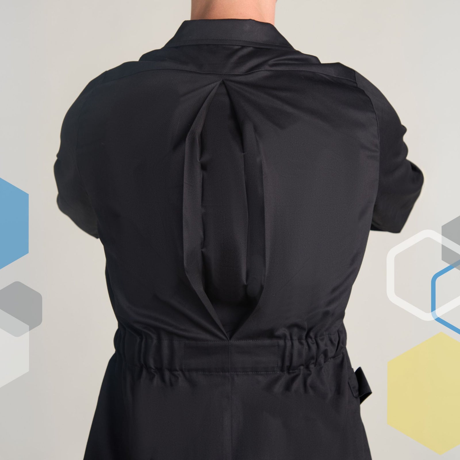men's tailored black cotton lab coat with extra shoulder room using an expandable back pleat for extra room to reach in the fume hood in a chemistry laboratory