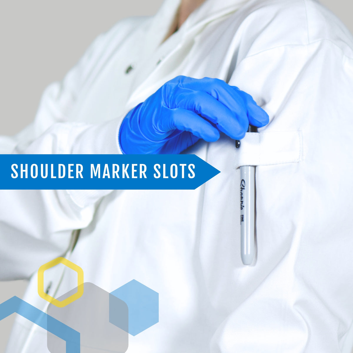 a woman 7 months pregnant sliding a black marker into a shoulder loop of a maternity lab coat for tool storage away from her chest