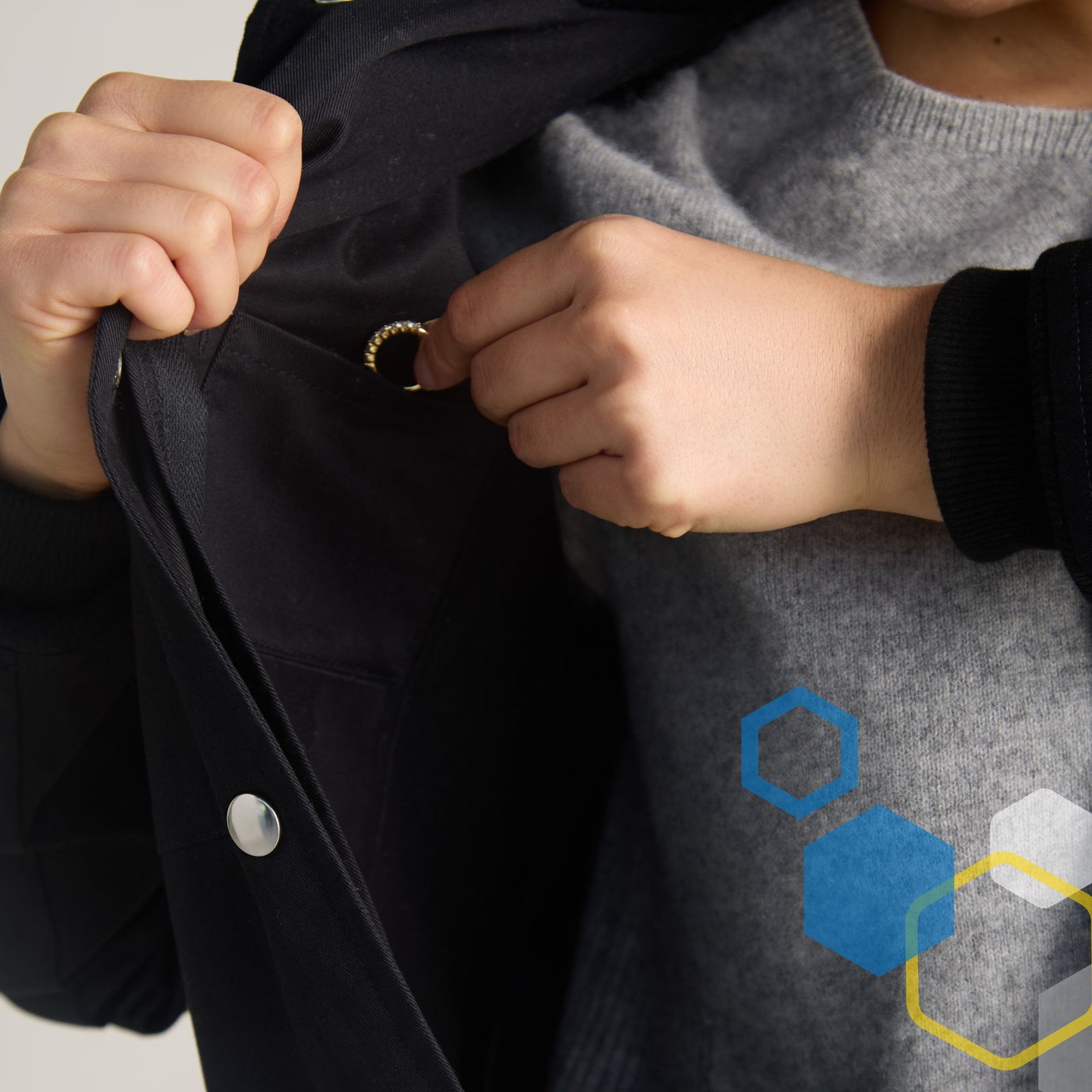 Women's cotton lab coat with a small hidden valuables pocket inside the upper breast pocket, close-up detail
