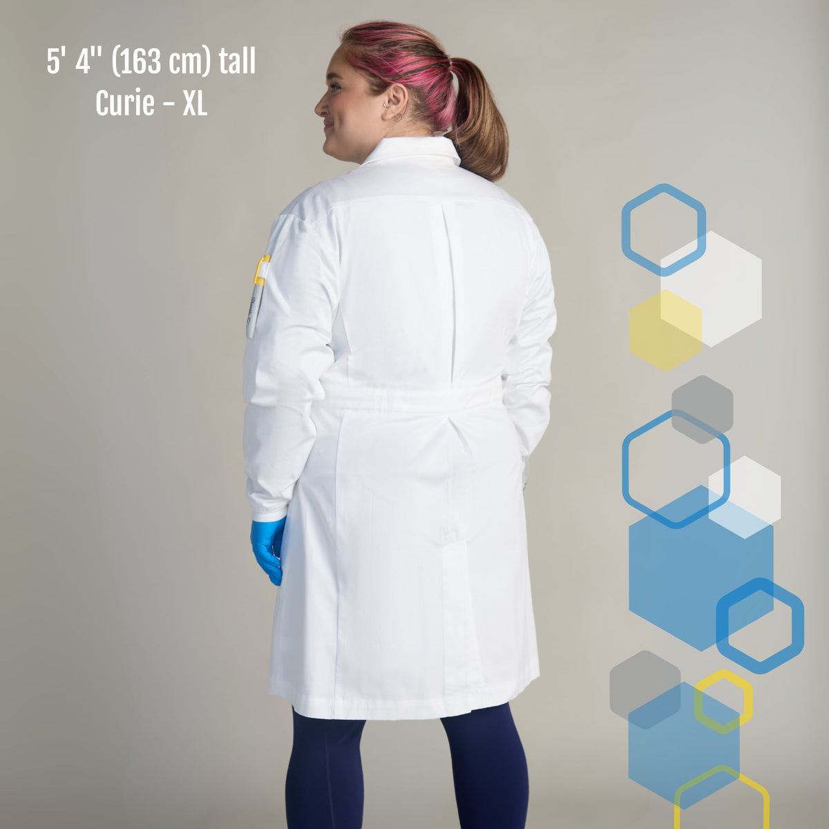 female xl lab coat with wider hips and rear pleats. White color with woman smiling in a college chemistry classroom