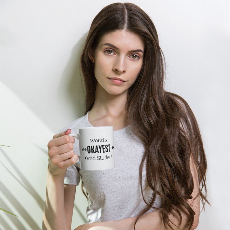 World's OKAYEST Grad Student Coffee Mug held by a lady